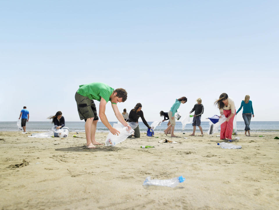 Young people collecting rubbish on a beach in Cornwall (Getty Images)