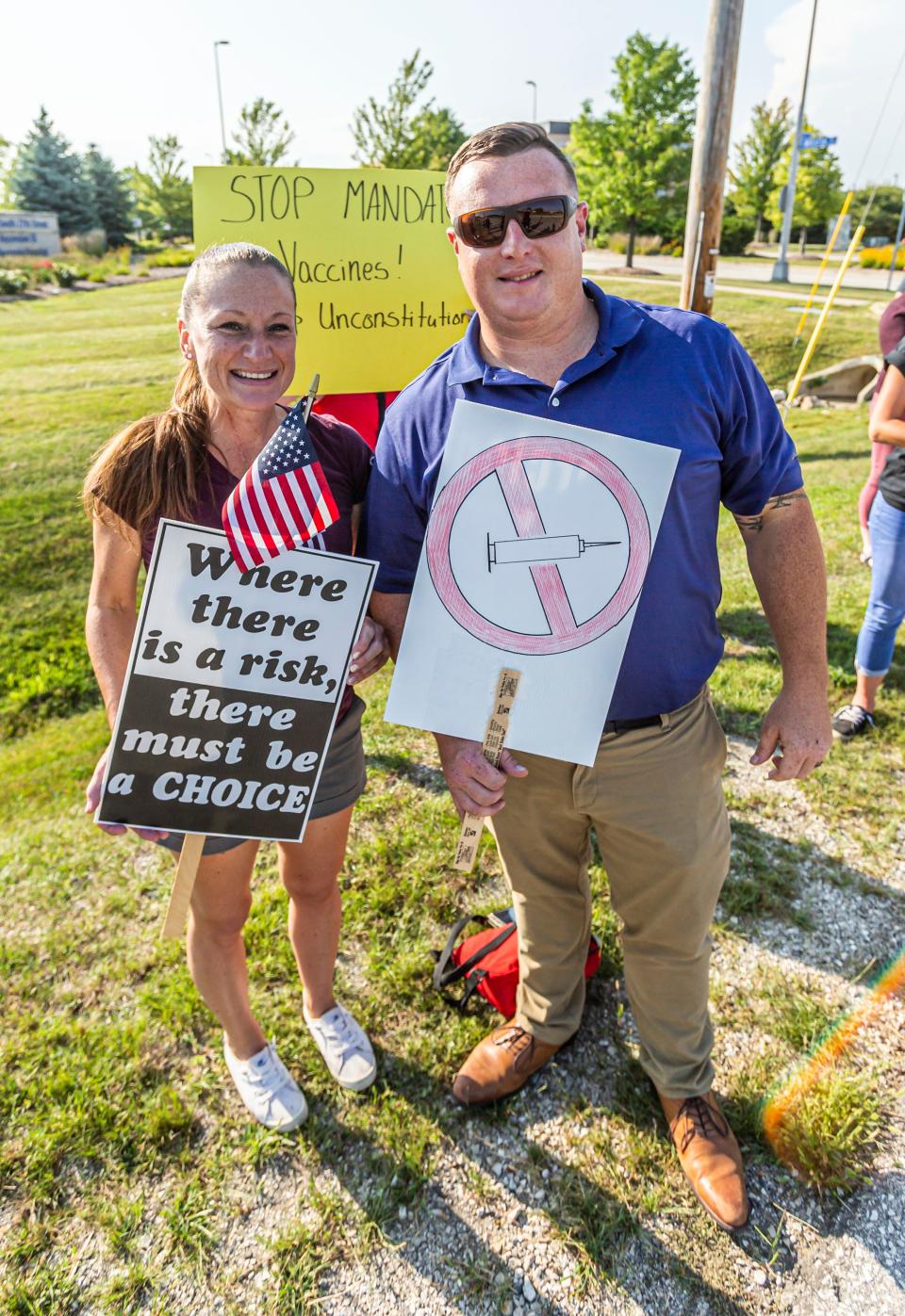 A protestor and Republican candidate for Wisconsin Secretary of State, Justin Schmidtka, stand in front of Ascension SE Wisconsin Hospital in Franklin during a rally against mandatory vaccination versus termination on Friday, August 27, 2021.