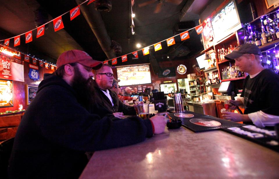 Adrian Fryxell and Brad Thomas, left to right, have drinks at The Half Barrel in Knoxville, Tennessee, on Dec. 22, 2010. While this bar remains open today, Cumberland Avenue is changing, and Knox News wants to document how students past and present experienced "the Strip" while attending the University of Tennessee at Knoxville.