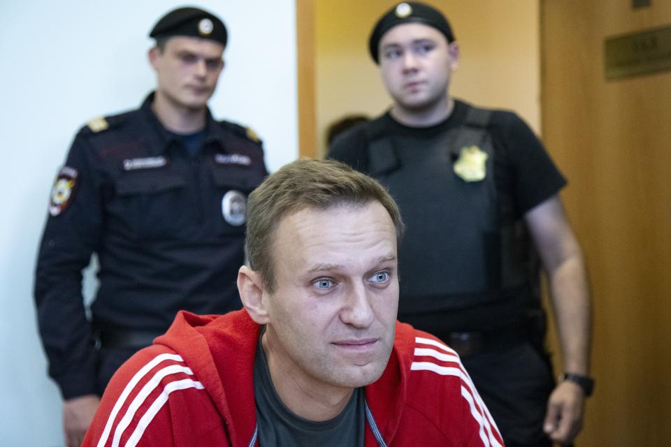 Russian leader Alexei Navalny speaks to the media prior to a court session in Moscow, Russia, Thursday, Aug. 22, 2019. Navalny is due in court, where a judge will consider extending his detention in lieu of days spent in hospital, where he was being treated for an allergic attack at the end of July. Navalny was due to be released on Friday after serving 30 days for calling an unsanctioned protest. (AP Photo/Alexander Zemlianichenko)