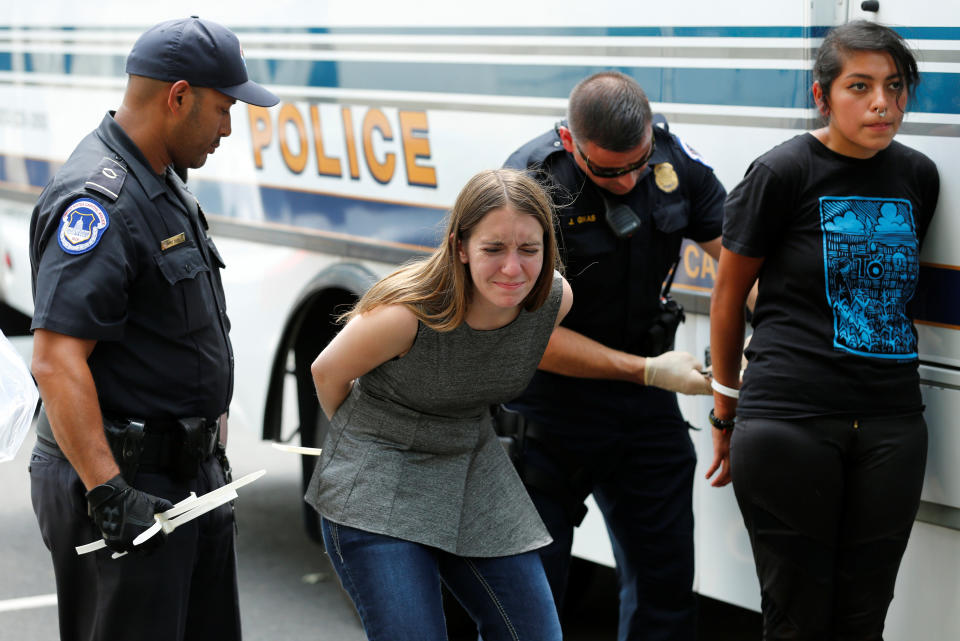 Health care activists are detained after the protest.