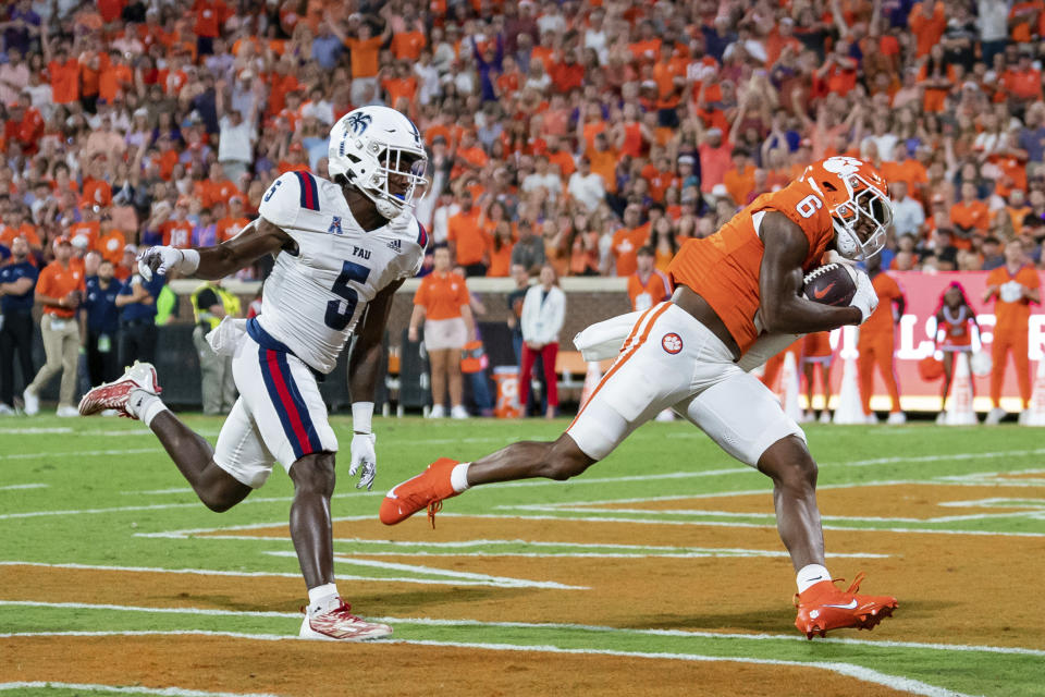 Clemson wide receiver Tyler Brown (6) catches a pass for a touchdown while covered by Florida Atlantic cornerback Jayden Williams (5) during the first half of an NCAA college football game Saturday, Sept. 16, 2023, in Clemson, S.C. (AP Photo/Jacob Kupferman)