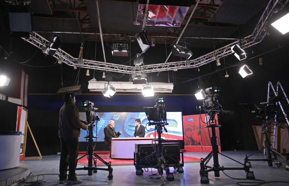 In this Monday, Feb. 3, 2014 photo, Tolo TV staffers work in a studio at the Tolo TV building in Kabul, Afghanistan. The proliferation of Afghan media in the past 12 years is one of the most visible bright spots of the fraught project to foster a stable democracy. (AP Photo/Massoud Hossaini)