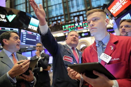 Traders work on the floor at the New York Stock Exchange (NYSE) in New York, U.S., April 18, 2019. REUTERS/Brendan McDermid