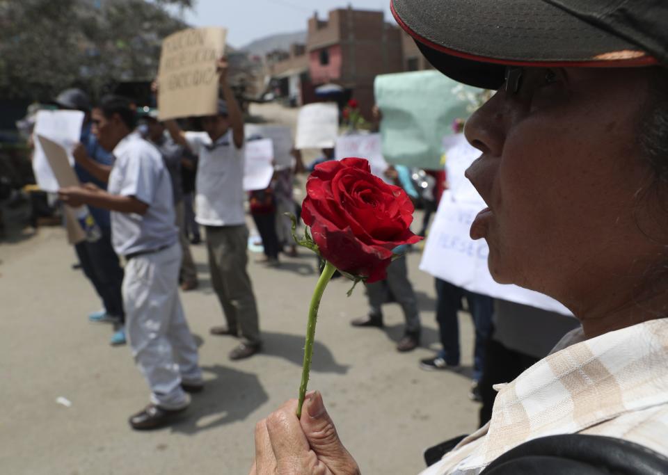 Relatives protest as Peruvian authorities demolish a Shining Path mausoleum in a cemetery on the outskirts of Lima, Peru, Saturday, Dec. 29, 2018. Peruvian authorities destroyed the mausoleum on Saturday where eight Shining Path prisoners were killed in a massacre that took place in a prison more than three decades ago. They relocated the remains to a cemetery in a neighborhood in the northern part of the capital. (AP Photo/Martin Mejia)