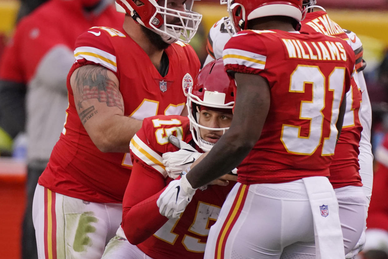 Kansas City Chiefs quarterback Patrick Mahomes (15) is helped up by teammates after getting injured during the second half against the Browns. (AP Photo/Charlie Riedel)