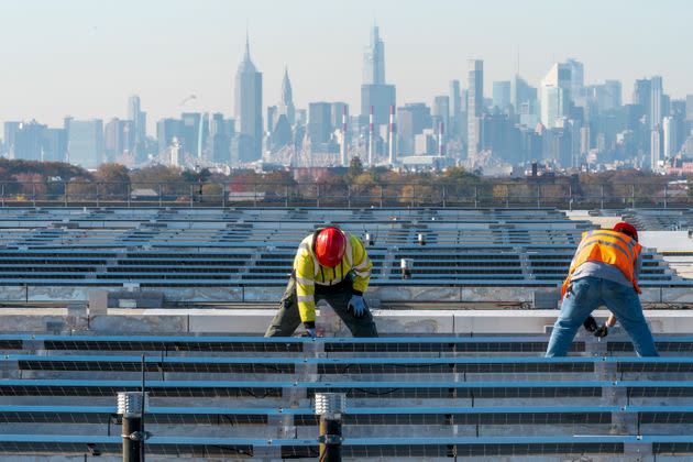 Union electricians install solar panels on top of the Terminal B garage at LaGuardia Airport in November 2021. (AP Photo/Mary Altaffer, File) (Photo: via Associated Press)