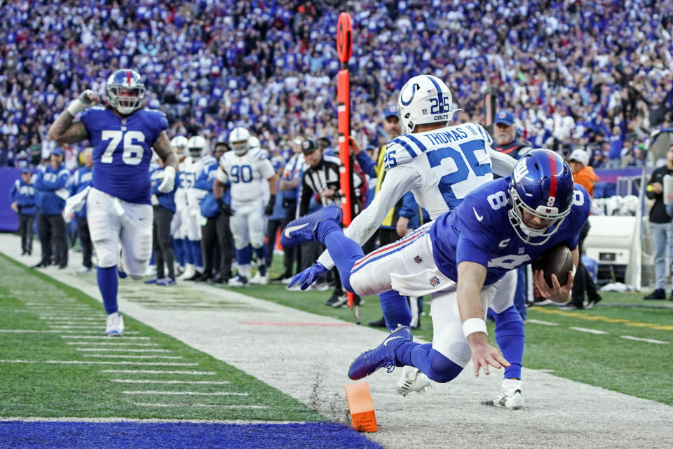 New York Giants' Daniel Jones (8) dives past Indianapolis Colts' Rodney Thomas II (25) for a touchdown during the second half of an NFL football game, Sunday, Jan. 1, 2023, in East Rutherford, N.J. (AP Photo/Bryan Woolston)