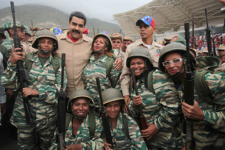 Venezuela's President Nicolas Maduro (back row 2nd L) poses for a photo with militia members during a military parade in La Guaira, Venezuela May 21, 2016. Miraflores Palace/Handout via REUTERS