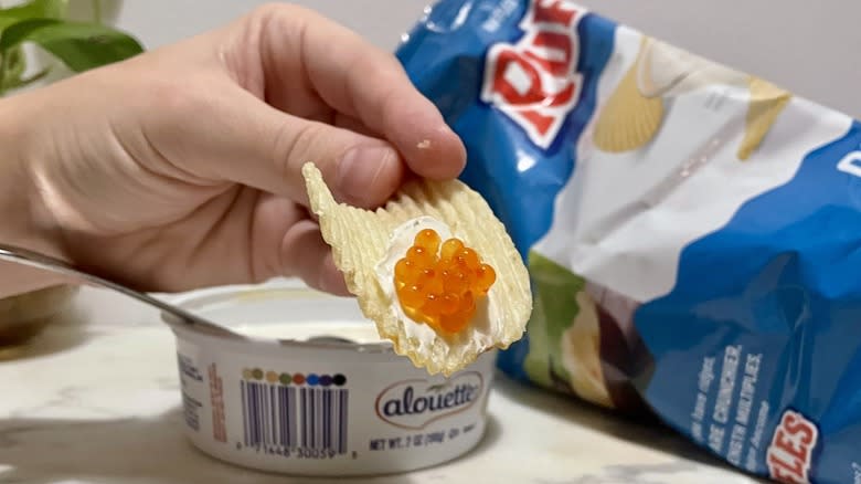 Holding chip with caviar and creme fraiche