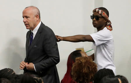 Sacramento Mayor Darrell Steinberg, (L), walks with Stevante Clark during the funeral services for police shooting victim, Stephon Clark at Bayside Of South Sacramento Church in Sacramento, California, U.S., March 29, 2018. Jeff Chiu/Pool via Reuters