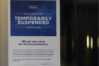 A information sign is seen at the Hilton Orrington/Evanston in Evanston, Ill., Saturday, Jan. 16, 2021. The Hilton Orrington/Evanston temporarily closed, citing coronavirus pandemic concerns. In Illinois alone, AHLA (American Hotel & Lodging Association) found about 26,000 hotel-related jobs have been lost due to the pandemic. (AP Photo/Nam Y. Huh)