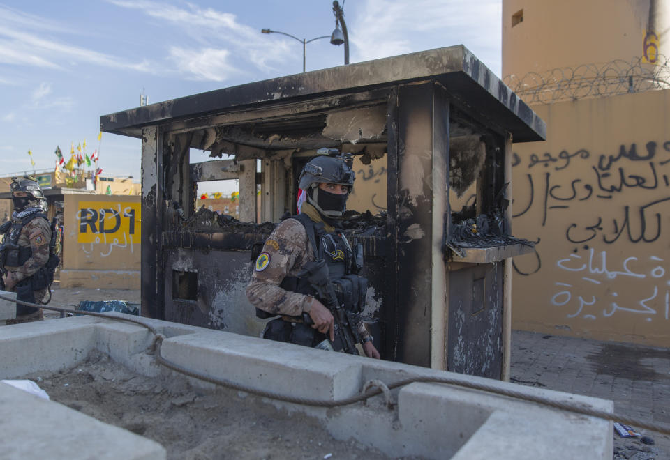 Iraqi army soldiers are deployed in front of the U.S. embassy, in Baghdad, Iraq, Wednesday, Jan. 1, 2020. Iran-backed militiamen have withdrawn from the U.S. Embassy compound in Baghdad after two days of clashes with American security forces. (AP Photo/Nasser Nasser)