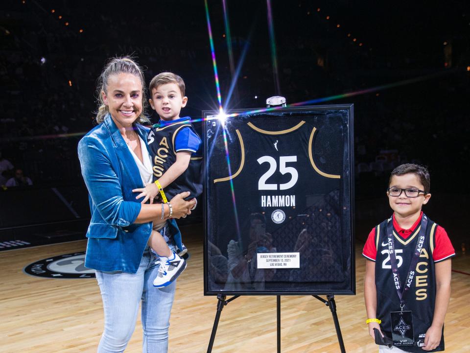 Becky Hammon celebrates with her sons as the Las Vegas Aces retire her jersey.