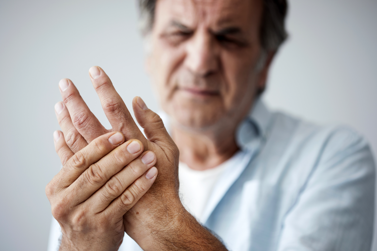 Man experiencing arthritis pain in his hand