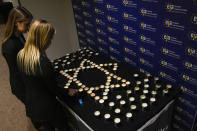 Staff members arrange candles before the start of the European Jewish Association's conference, in Krakow, Poland, Monday, Jan. 22, 2024. Musk visited earlier in the day the site of the Auschwitz-Birkenau Nazi German death camp in Oswiecim, Poland, the private visit apparently took place in response to calls from some Jewish religious leaders for Musk to see with his own eyes the most symbolic site of the horrors of the Holocaust. (AP Photo/Czarek Sokolowski)