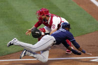 Tampa Bay Rays' Manuel Margot, below, scores after a single by Brandon Lowe and a fielding error by Los Angeles Angels second baseman David Fletcher as catcher Max Stassi takes a late throw during the first inning of a baseball game Tuesday, May 4, 2021, in Anaheim, Calif. (AP Photo/Mark J. Terrill)