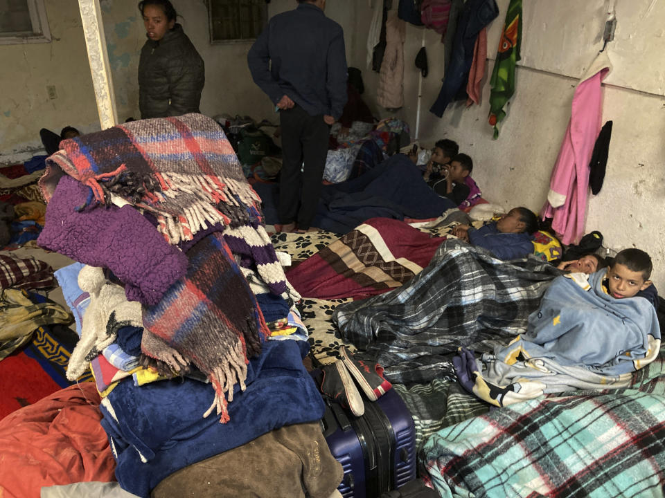Migrants seek refuge from winter weather in a crowded shelter near the U.S. border in Ciudad Juárez, Mexico, on Thursday, Dec. 22, 2022. Hundreds of migrants are gathered in unusually frigid cold temperatures along the Mexican-U.S. border near El Paso, Texas, awaiting a U.S. Supreme Court decision on whether and when to lift pandemic-era restrictions that prevent many from seeking asylum. (AP Photo/Morgan Lee)