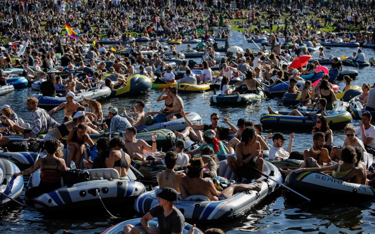 People attend a rave in boats of all sizes to give support to Berlin's world renowned dance clubs which are struggling due to coronavirus COVID-19 pandemic on the Landwehr canal on May 31, 2020 in Berlin's Kreuzberg district. (Photo by David GANNON / AFP) (Photo by DAVID GANNON/AFP via Getty Images) - DAVID GANNON/AFP