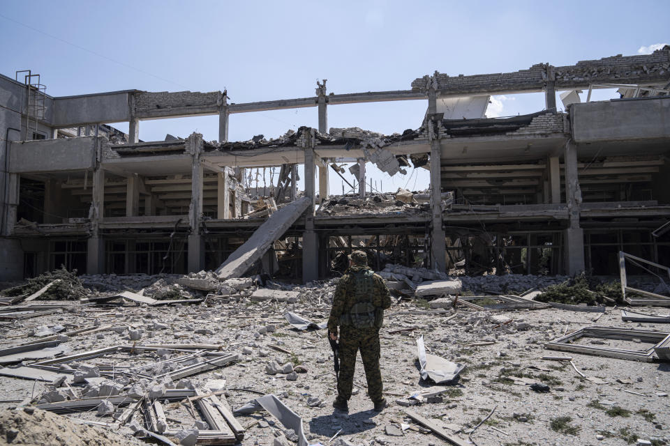 Ukrainian serviceman looks on National Pedagogic university destroyed by a Russian attack in Kharkiv, Ukraine, Wednesday, July 6, 2022. (AP Photo/Evgeniy Maloletka)