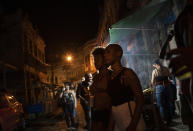 Women listen to a street performance by the Brazilian band Atitude Nossa as the restrictions related to the COVID-19 pandemic are eased in Rio de Janeiro, Brazil, Monday, Oct. 5, 2020. Since the beginning of October, live shows are now permitted in Rio de Janeiro. (AP Photo/Silvia Izquierdo)