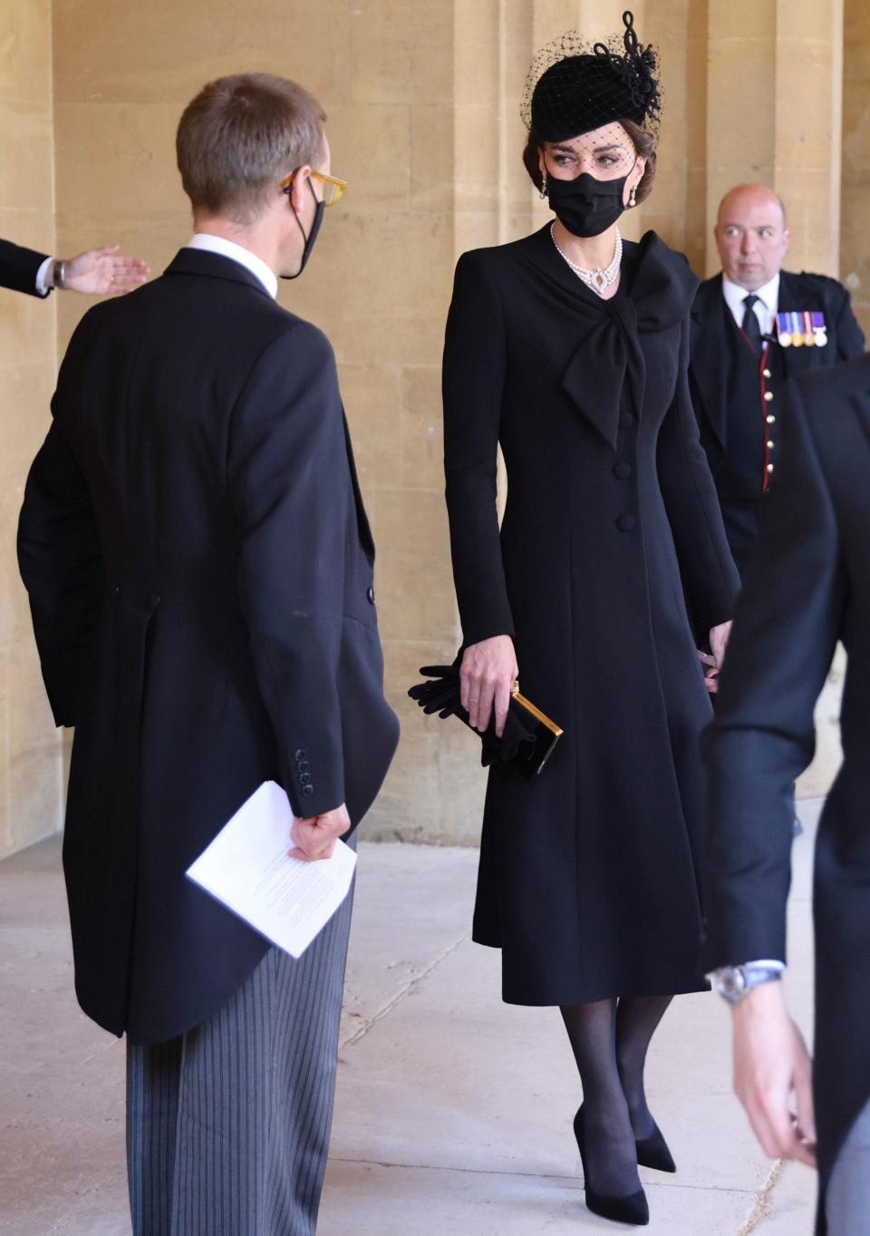 The Duchess of Cambridge at the Duke of Edinburgh's funeral in April 2021 wearing a Catherine Walker & Co coat and a Roland Mouret dress with a four strand diamond clasped pearl choker and her diamond earrings, both borrowed from the Queen - Getty Images