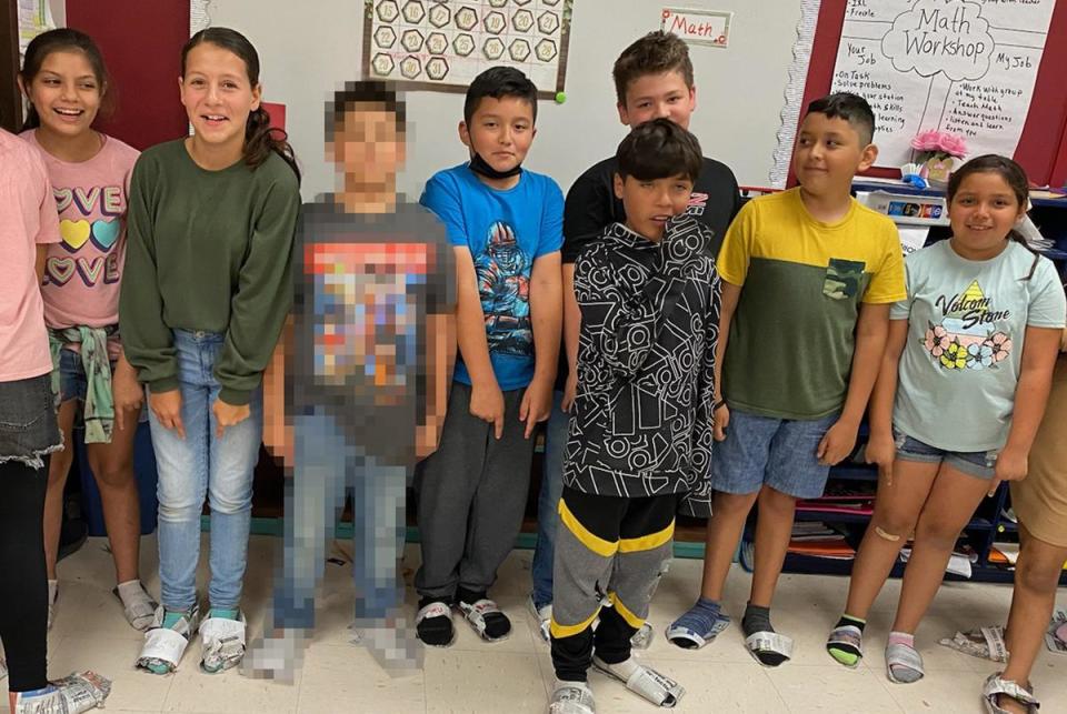 Elsa Avila’s students pose for a picture in their newspaper shoes moments before the shooter entered their school. Children’s faces are shown with parental consent.