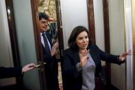 Acting Cabinet director Jorge Moragas (L) and acting Deputy Prime Minister Soraya Saenz de Santamaria arrives at the news conference of Spain's acting Prime Minister Mariano Rajoy (not pictured) at Parliament in Madrid, Spain, February 12, 2016. REUTERS/Juan Medina