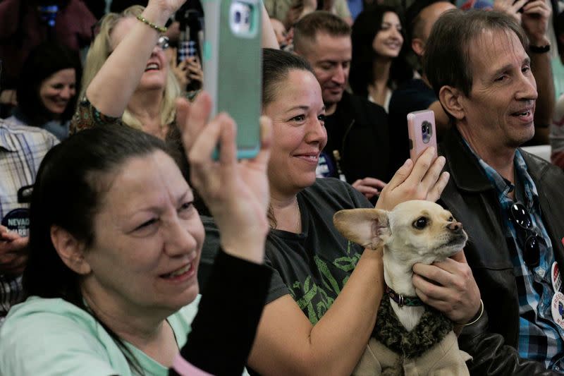 FILE PHOTO: Elyse Petersen holds her dog, Bitcoin, as U.S. Democratic presidential candidate Senator Elizabeth Warren holds a "Canvass Kickoff" event at her campaign field office in North Las Vegas