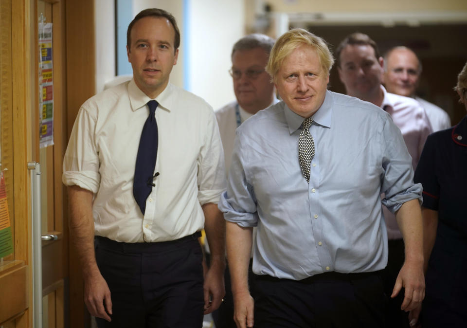 FILE - In this Friday, Nov. 22, 2019 file photo, Britain's Prime Minister Boris Johnson, right, and Health Minister Matt Hancock visit Bassetlaw District General Hospital on their General Election campaign in Worksop, England. Matt Hancock has tested positive for the new coronavirus, Friday March 27, 2020, the same day as Prime Minister Boris Johnson was confirmed to have COVID-19. (Christopher Furlong/Pool via AP, File)