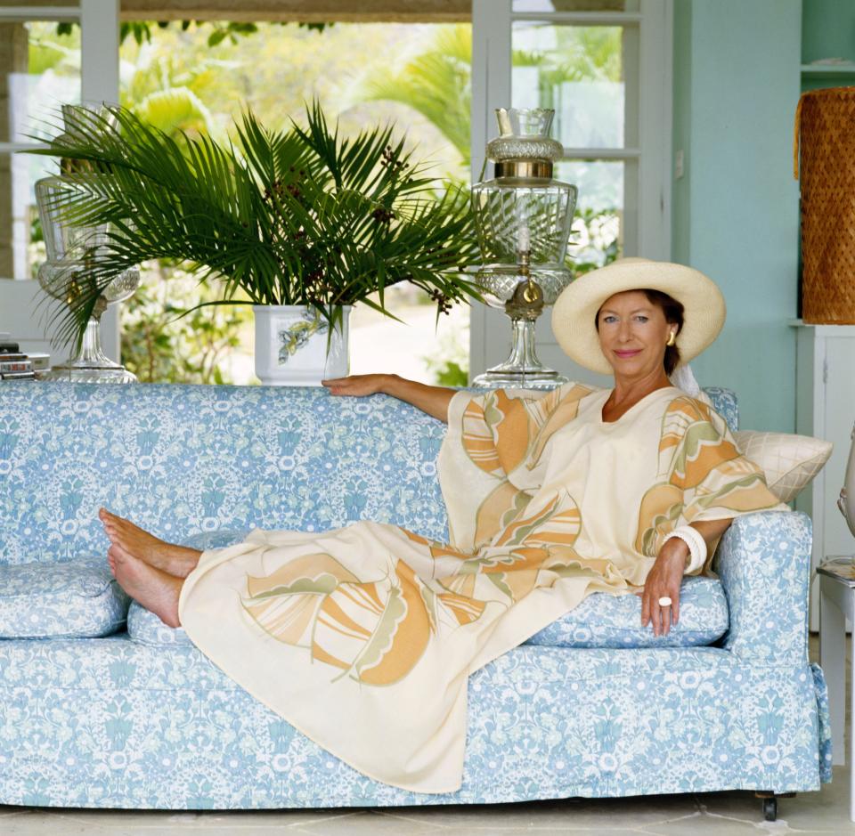 Princess Margaret reclining on a sofa at her home, Les Jolies Eaux, on Mustique in April 1976.