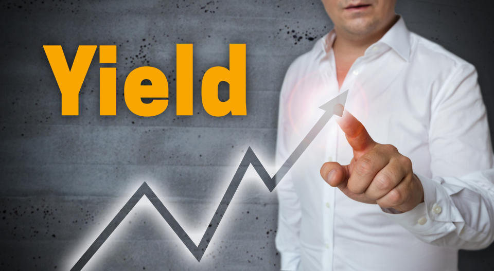 Man pointing to an line trending up with the word Yield printed above the line