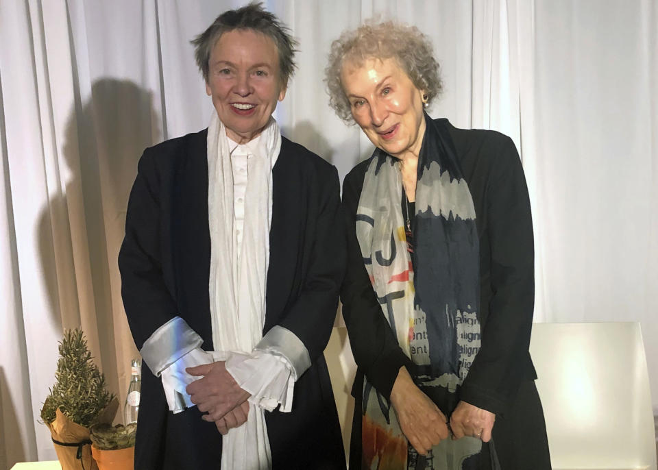 American avant-garde artist, composer, musician and film director Laurie Anderson, left, and Canadian author Margaret Atwood pose for photographs before speaking together at an event sponsored by the MacDowell Colony, Monday, Dec. 9, 2019, in New York. (AP Photo/Hillel Italie)