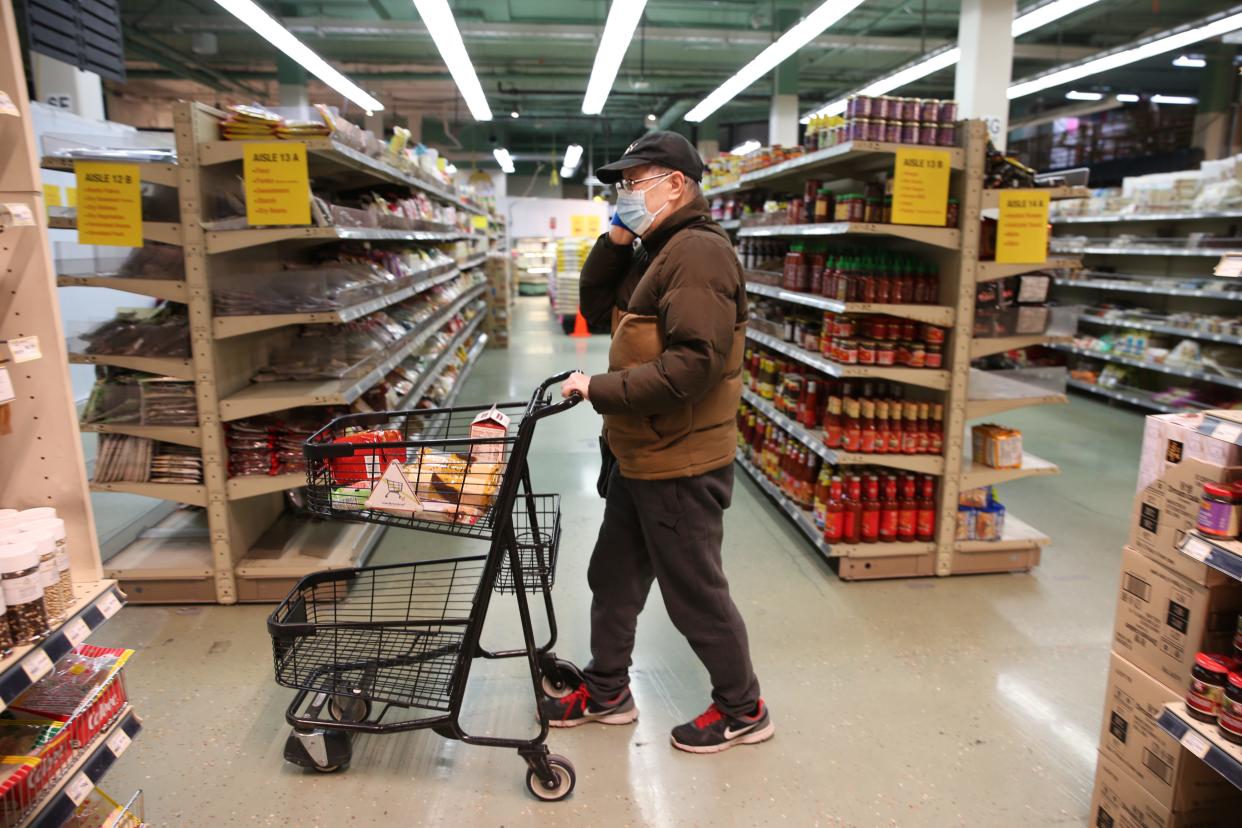 Check Chen from Seattle, shops for groceries during special hours open to seniors only at Uwajimaya, an Asian specialty supermarket, on March 18, 2020 in Seattle, Washington.