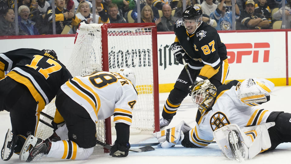 Pittsburgh Penguins' Bryan Rust (17) pushes the puck into the net past Boston Bruins goaltender Linus Ullmark (35) for a goal during the second period of an NHL hockey game Tuesday, Nov. 1, 2022, in Pittsburgh. (AP Photo/Keith Srakocic)