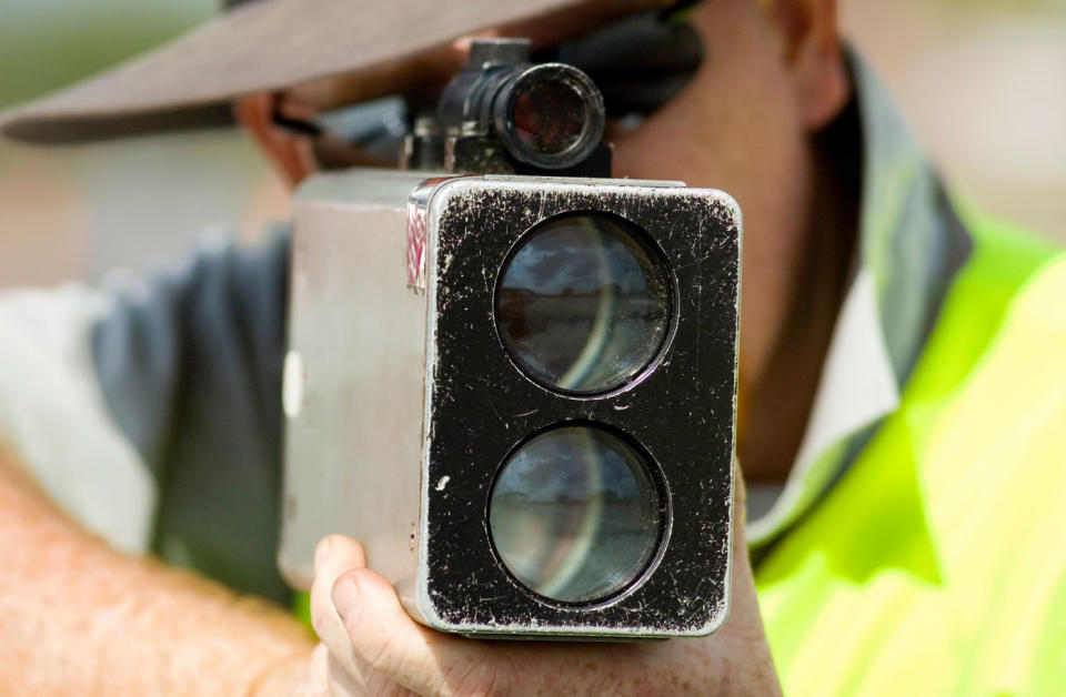 A man is pictured holding a speed camera.