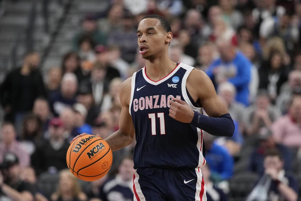 Gonzaga's Nolan Hickman (11) dribbles down the court in the first half of a Sweet 16 college basketball game against UCLA in the West Regional of the NCAA Tournament, Thursday, March 23, 2023, in Las Vegas. (AP Photo/John Locher)