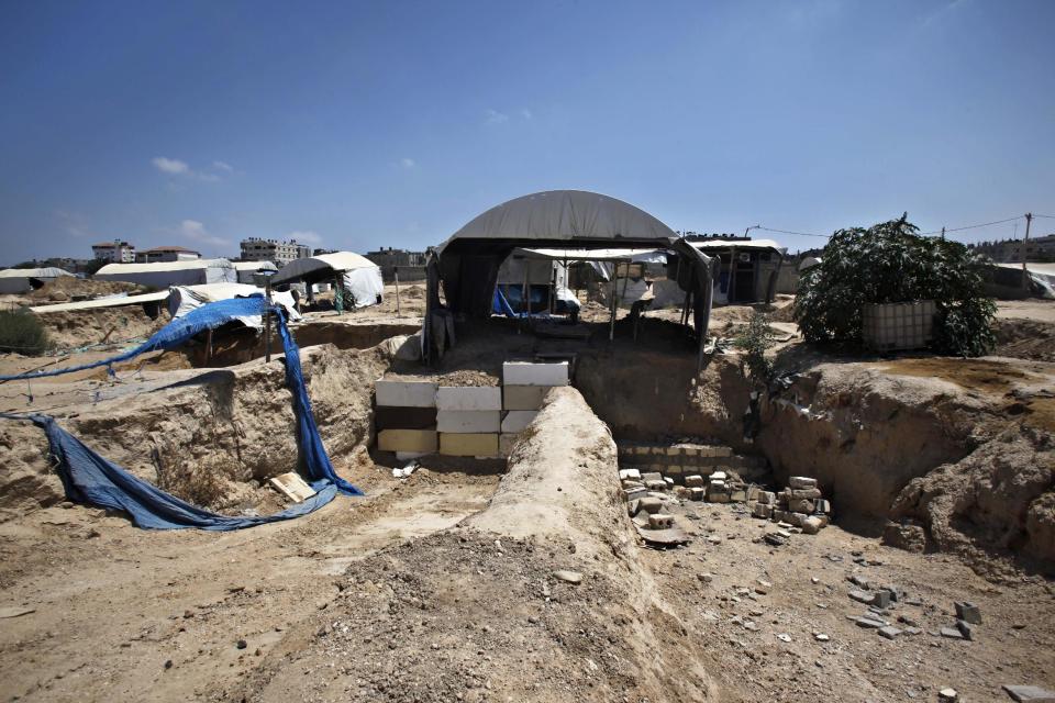 FILE - In this Wednesday, July 24, 2013 file photo, the entrance to smuggling tunnels are blocked along the border between the Gaza Strip and Egypt, in Rafah, southern Gaza Strip. An Egyptian court ruled on Tuesday, March 4, 2014 to ban activities of the Palestinian militant group Hamas in Egypt in a move likely to fuel tension between Cairo's military-backed government and the Islamic group that rules the neighboring Gaza Strip. Authorities have also destroyed many of the tunnels running under the Egypt-Gaza border and which are used by Palestinians in Gaza to smuggle a wide range of goods from Egypt, including subsidized items like gasoline and medicine. (AP Photo/Adel Hana, File)