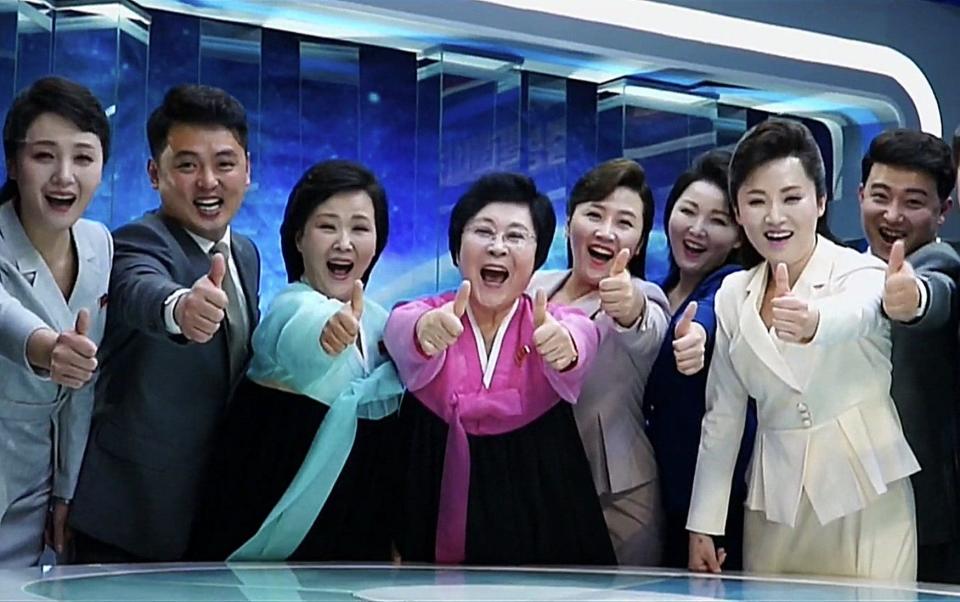 North Koreans give the thumbs-up in the video designed to bolster their dictator's image