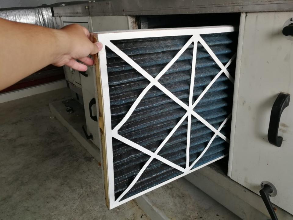 Replacing air filter in HVAC system.