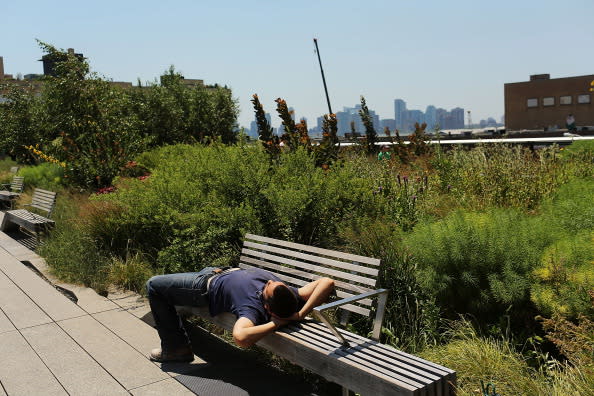 A man relaxes on a bench in the along the High Line park during warm weather on July 6, 2012 in New york City. Forecasts for tomorrow are predicting temperatures near 100 degrees Fahrenheit (38 Celsius) and may feel as hot as 106 because of humidity, according to the National weather Service. Much of the midwest of the United States has been experiencing a severe heat wave which has devastated crops and kept people indoors.(Photo by Spencer Platt/Getty Images)