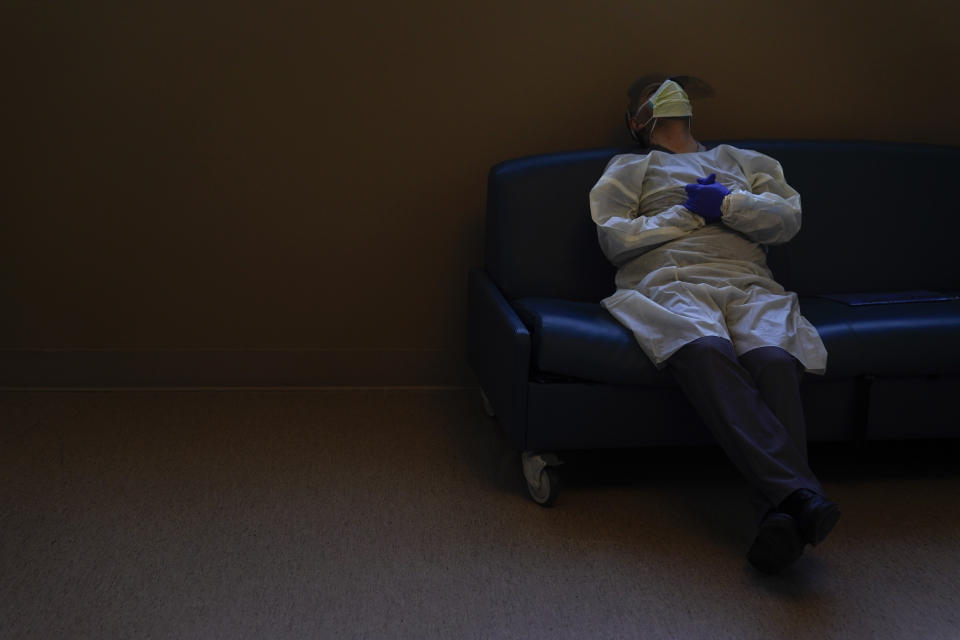 FILE - Dr. Mher Onanyan takes a short break while waiting for an X-ray of a COVID-19 patient's lungs at Providence Holy Cross Medical Center in the Mission Hills section of Los Angeles, Dec. 22, 2020. The U.S. death toll from COVID-19 has hit 1 million, less than 2 1/2 years into the outbreak. (AP Photo/Jae C. Hong, File)