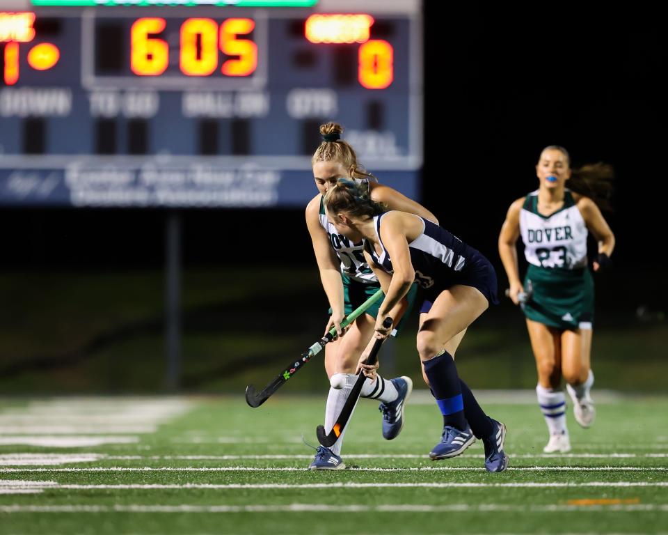 Exeter's Garen Steiner looks to make a stop on Dover's Audrey Carter during Tuesday's Division I field hockey semifinal.