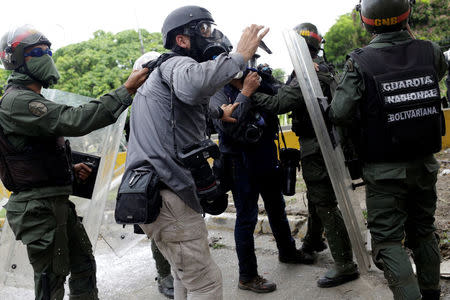 Members of the media argue with riot security forces during a rally against Venezuela's President Nicolas Maduro in Caracas, Venezuela, May 31, 2017. REUTERS/Marco Bello