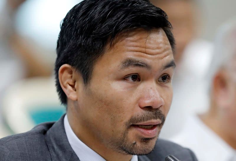 FILE PHOTO: Philippine Senator and boxer Manny Pacquiao speaks during the Congressional confirmation hearing of Environment Secretary Regina Lopez at the Senate in Manila