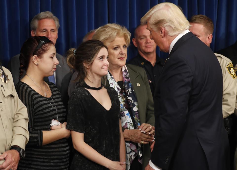 Donald Trump is greeted by survivor family members Shelby Stalker and Stephanie Melanson (Reuters)