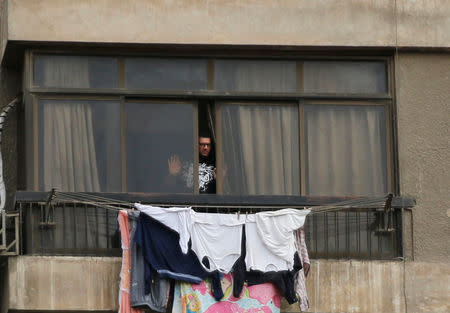 A building resident looks towards the site of an explosion in the building's garden, where the Interior Ministry said an unidentified metallic object was found, in the Cairo suburb of Maadi, Egypt, March 24, 2017. REUTERS/Amr Abdallah Dalsh