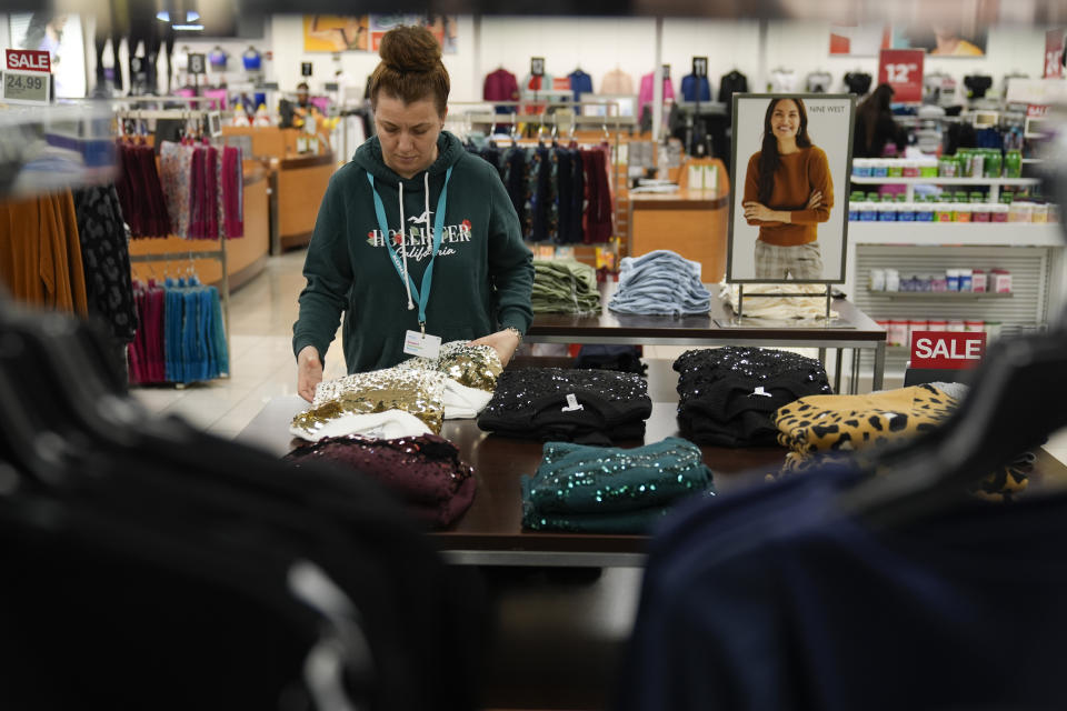 FILE - An employee straightens displays at a Kohl's store in Clifton, N.J., Jan. 26, 2024. On Friday, March 8, 2024, the U.S. government issues its February jobs report. (AP Photo/Seth Wenig, File)