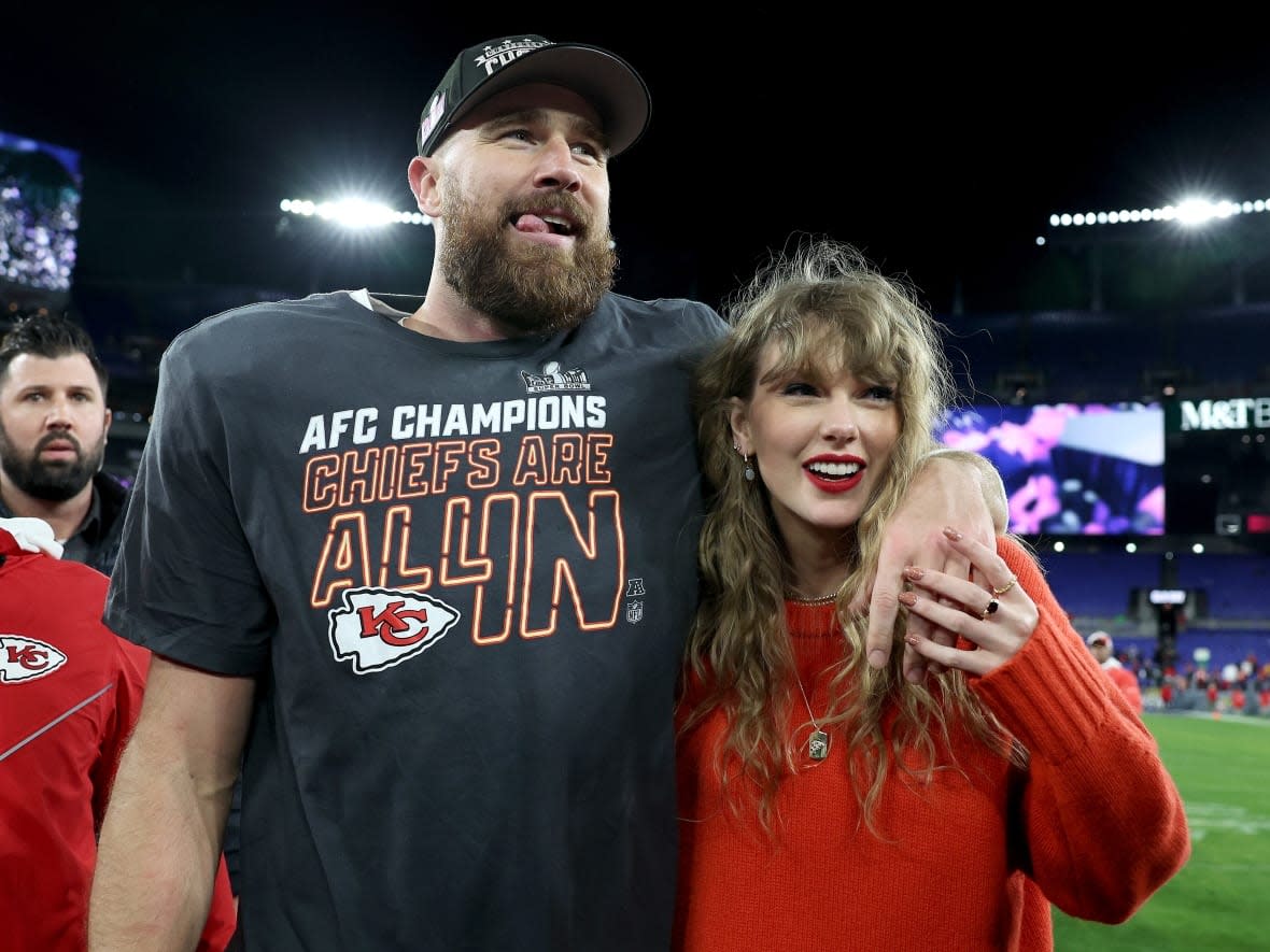 Kansas City tight end Travis Kelce celebrates with Taylor Swift after a 17-10 victory over the Baltimore Ravens in the AFC Championship on Jan. 28. A Kelce jersey signed by the couple is up for auction by a Guelph, Ont., children's charity. (Patrick Smith/Getty Images - image credit)