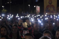 People gather for a protest prayer led by the Serbian Orthodox Church against the holding of an LGBTQ pride march this weekend in Podgorica, Montenegro, Friday, Oct. 7, 2022. The influential church has called its followers in Montenegro to join the prayer for "the sanctity of marriage and preservation of family" after organizing a similar gathering in neighboring Serbia ahead of a pan-European pride event there last month. (AP Photo/Risto Bozovic)